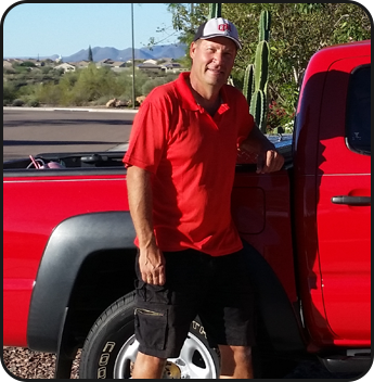 Owner Ken Kucera Standing Next to a Work Truck